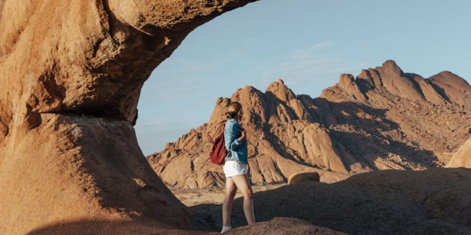 Woman Standing Near the Beautiful Rock Formation