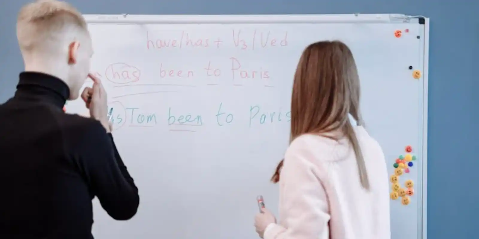 a woman writing on a Whiteboard