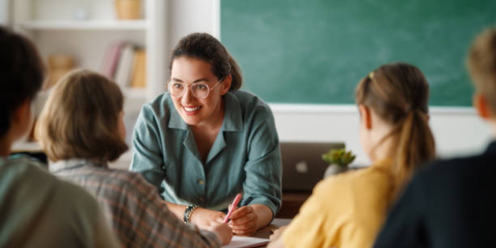 Woman and students talking in the class.