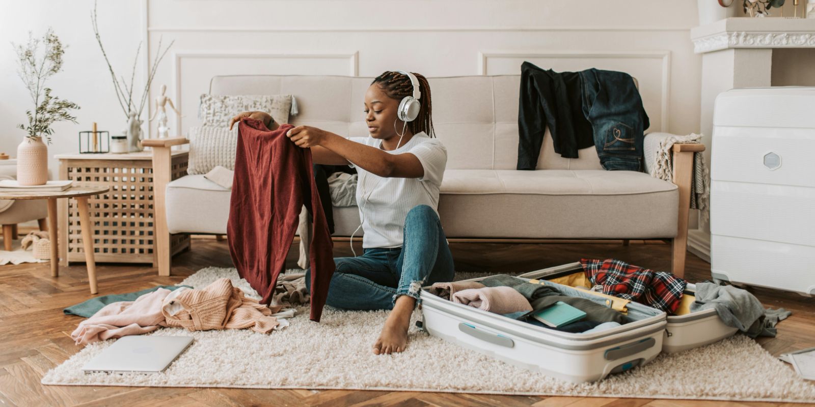 a woman listening to her headphones while packing