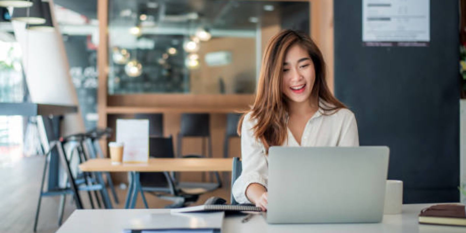 Young woman working at laptop in the office.