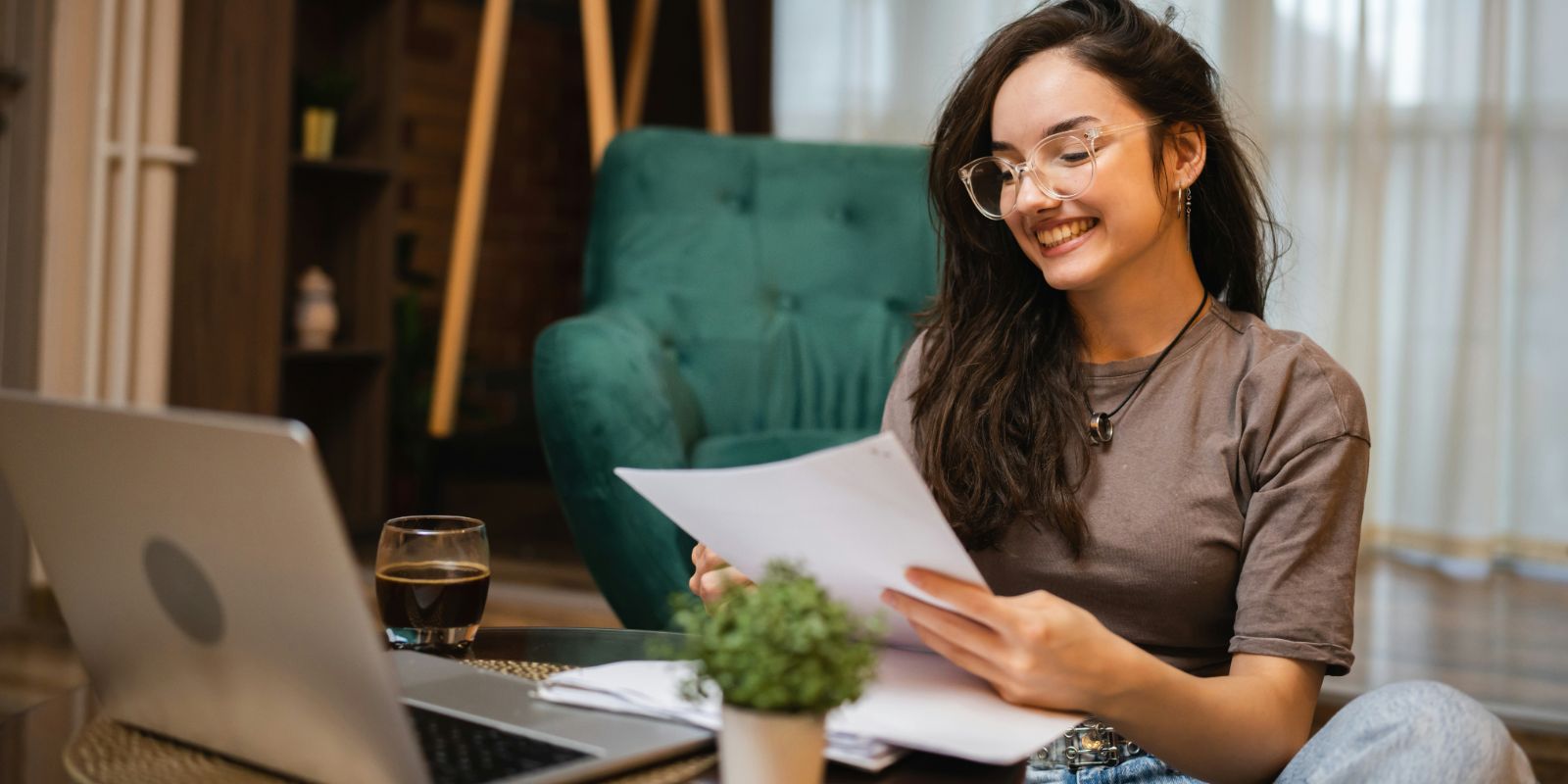 A woman studying in front of a laptop computer at home.