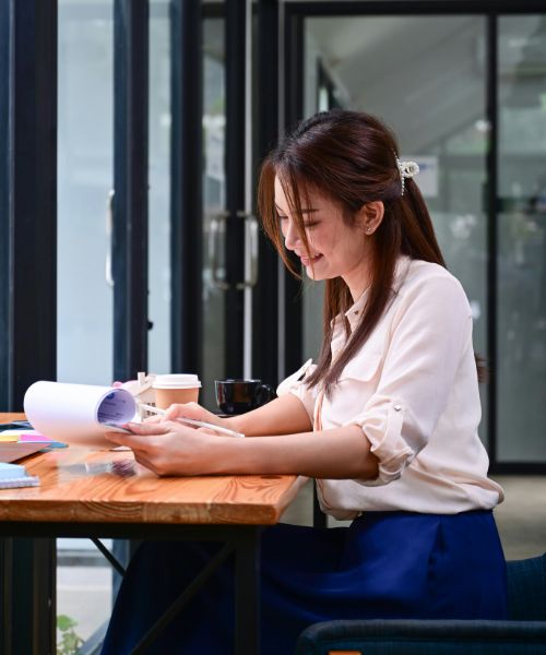 A young lady reading her work permit.