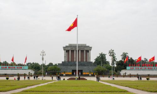Ho Chi Minh Mausoleum with Vietnamese flag in Hanoi