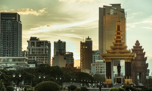 Park monument and Phnom Penh skyline at sunset